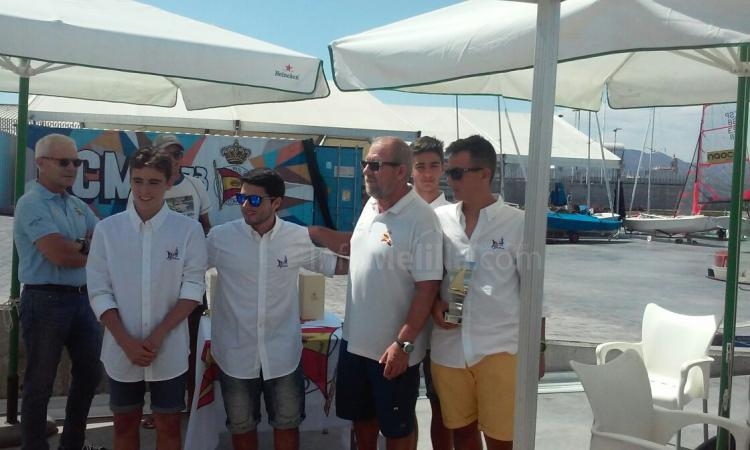 Los regatistas mas jóvenes de la tripulación recogiendo el trofeo